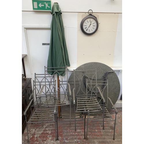 293 - A wrought metal seven piece patio set comprising circular granite top table and six chairs, together... 