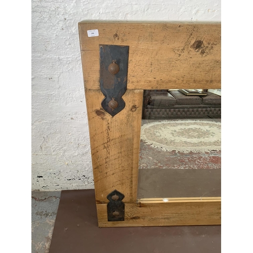 296 - A modern pine framed wall mirror with metal decoration - approx. 122cm high x 162cm wide