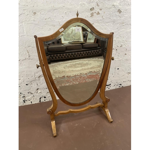 300 - An early 20th century Sheraton revival inlaid mahogany framed shield shaped swing dressing table mir... 