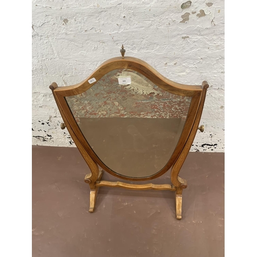 300 - An early 20th century Sheraton revival inlaid mahogany framed shield shaped swing dressing table mir... 