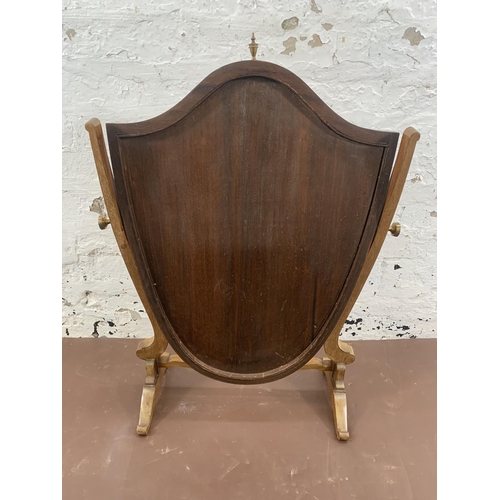 300 - An early 20th century Sheraton revival inlaid mahogany framed shield shaped swing dressing table mir... 