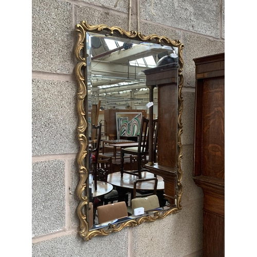 302 - A Rococo style gilt framed bevelled edge wall mirror - approx. 67cm high x 45cm wide