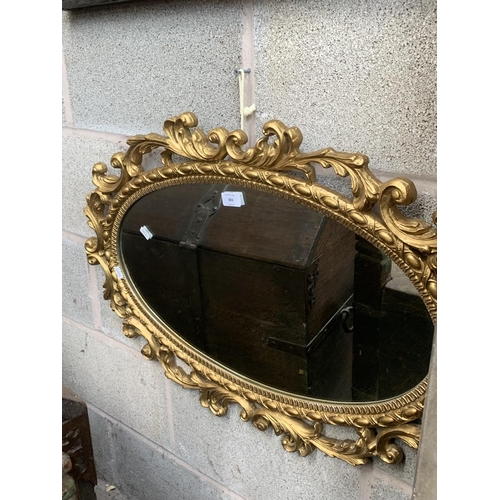 303 - A modern Rococo style oval gilt framed wall mirror - approx. 81cm high x 53cm wide