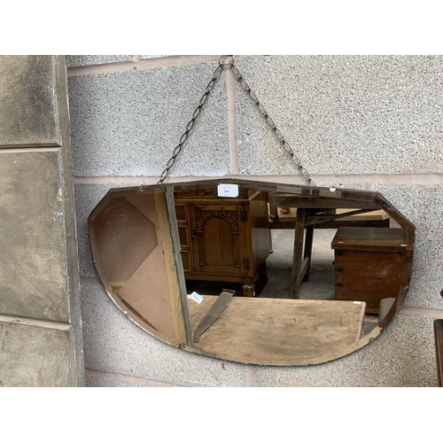 304 - A mid 20th century bevelled edge wall mirror - approx. 38cm high x 64cm wide