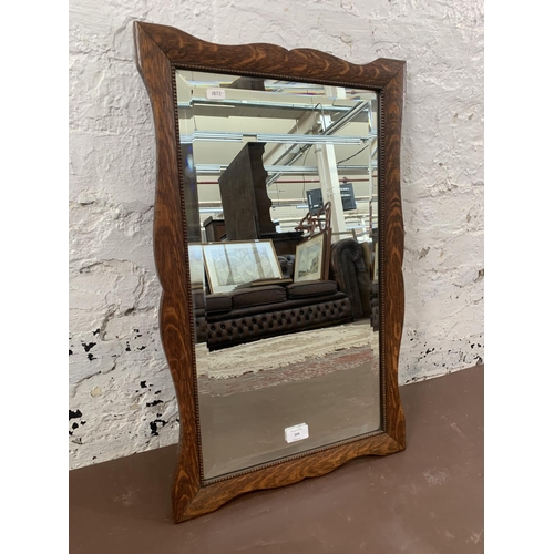 309 - An early 20th century oak framed bevelled edge wall mirror - approx. 62cm high x 42cm wide