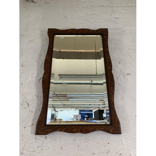 309 - An early 20th century oak framed bevelled edge wall mirror - approx. 62cm high x 42cm wide