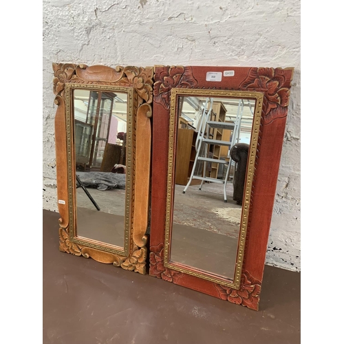 310 - Two modern oriental style decorative wall mirrors - approx. 64cm high x 34cm wide