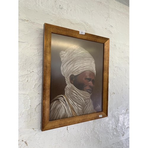 331 - A framed fabric portrait painting of an African gentleman, signed lower right - approx. 52cm high x ... 