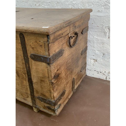 36 - A 19th century teak and iron banded chest - approx. 57cm high x 104cm wide x 47cm deep