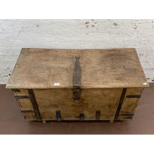 36 - A 19th century teak and iron banded chest - approx. 57cm high x 104cm wide x 47cm deep