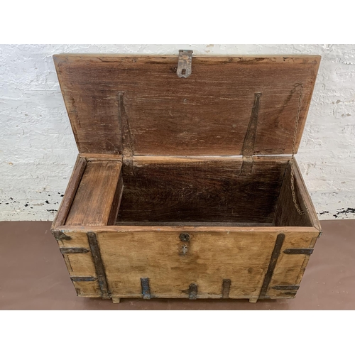 36 - A 19th century teak and iron banded chest - approx. 57cm high x 104cm wide x 47cm deep