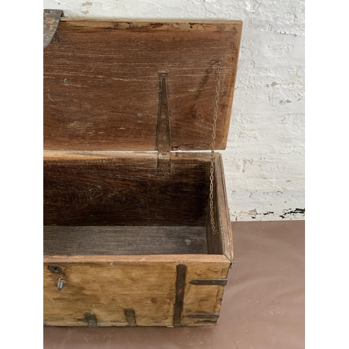 36 - A 19th century teak and iron banded chest - approx. 57cm high x 104cm wide x 47cm deep