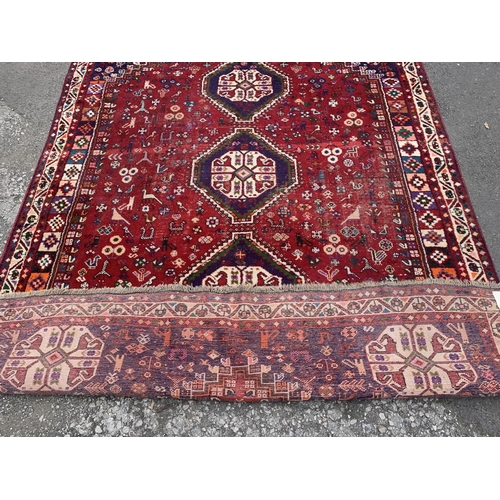 4 - A 20th century machine woven Shiraz rug - approx. 298cm x 210cm