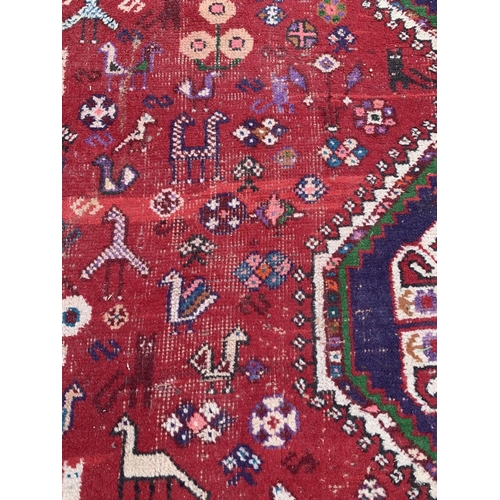 4 - A 20th century machine woven Shiraz rug - approx. 298cm x 210cm