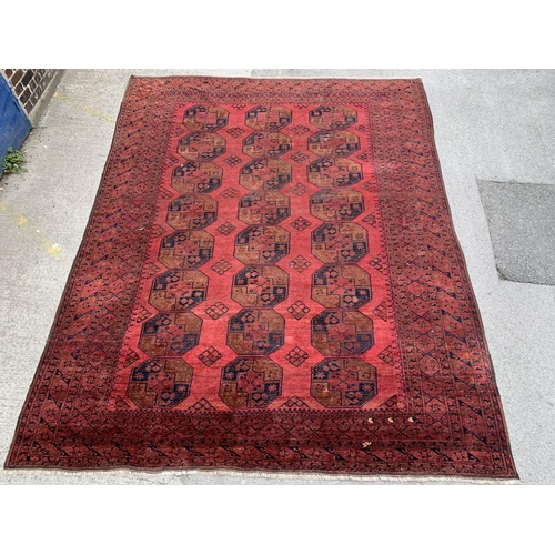 5 - A 20th century Afghan red ground rug - approx. 375cm x 285cm