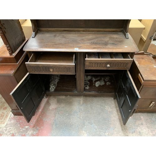 50 - A carved oak dresser - approx. 177cm high x 120cm wide x 47cm deep