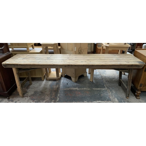 53 - An early 20th century pine trestle table - approx. 76cm high x 242cm wide x 60cm deep