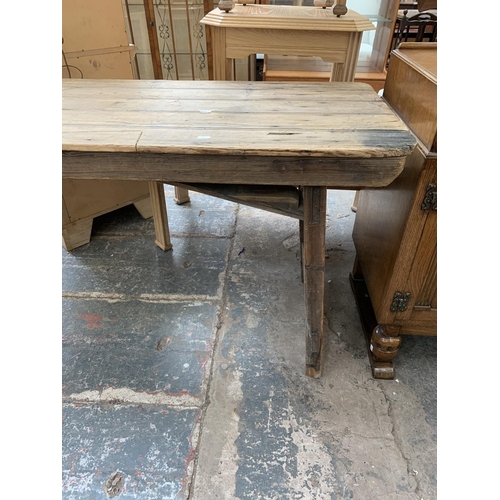 53 - An early 20th century pine trestle table - approx. 76cm high x 242cm wide x 60cm deep