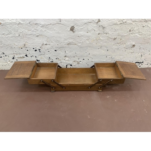 56 - A mid 20th century oak concertina sewing box - approx. 17cm high x 41cm wide x 22cm deep