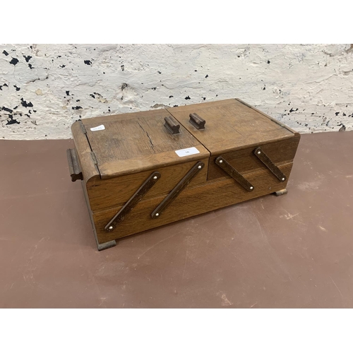 56 - A mid 20th century oak concertina sewing box - approx. 17cm high x 41cm wide x 22cm deep