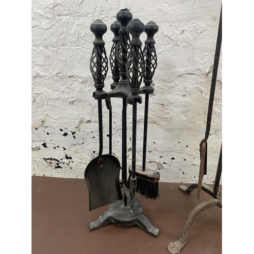 57 - Two wrought and cast iron companion sets - largest approx. 103cm high