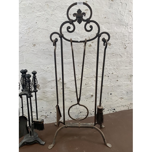 57 - Two wrought and cast iron companion sets - largest approx. 103cm high