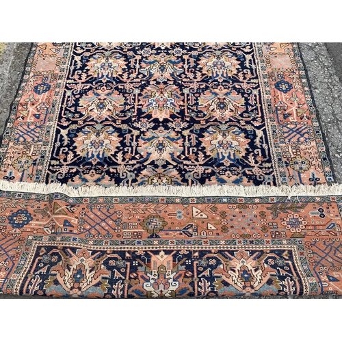 6 - A 20th century machine woven blue ground rug - approx. 230cm x 160cm