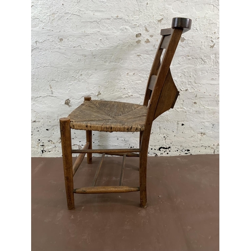66 - Four early 20th century beech and rush seated chapel chairs - approx. 82cm high x 40cm wide x 47cm d... 
