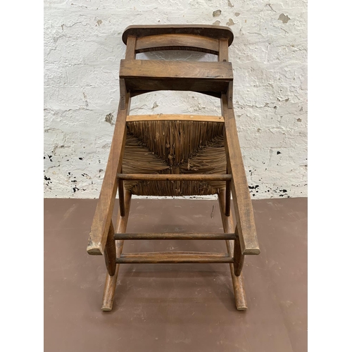 66 - Four early 20th century beech and rush seated chapel chairs - approx. 82cm high x 40cm wide x 47cm d... 