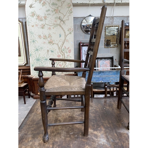 68 - A 17th century style solid oak refectory table and six Lancashire style elm and rush seated dining c... 