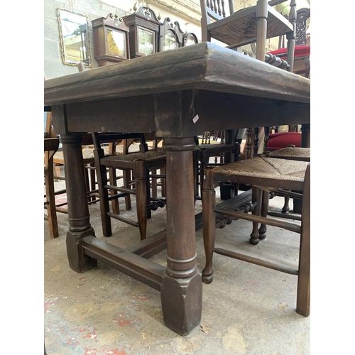 68 - A 17th century style solid oak refectory table and six Lancashire style elm and rush seated dining c... 