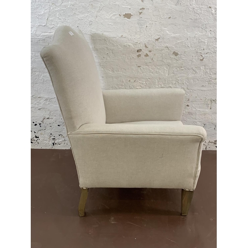 75 - An Edwardian fabric upholstered moustache top armchair - approx. 96cm high x 66cm wide x 66cm deep