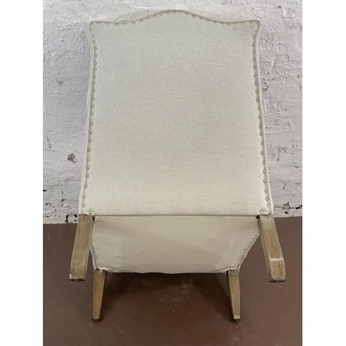 75 - An Edwardian fabric upholstered moustache top armchair - approx. 96cm high x 66cm wide x 66cm deep