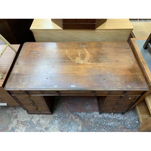 86 - A Victorian oak twin pedestal writing desk - approx. 75cm high x 142cm wide x 76cm deep