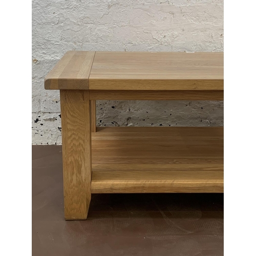 87 - A modern solid oak rectangular two tier coffee table - approx. 50cm high x 70cm wide x 120cm long