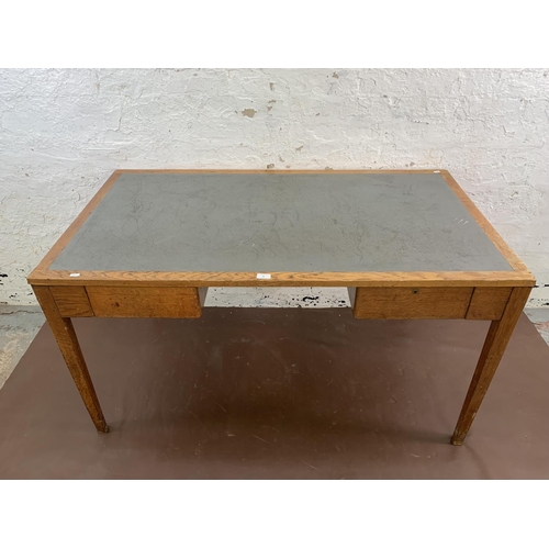 88 - A 1950s oak desk with grey painted writing surface, believed to be designed for the M.O.D. - approx.... 