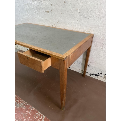 88 - A 1950s oak desk with grey painted writing surface, believed to be designed for the M.O.D. - approx.... 