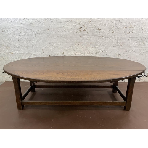 89 - An oak drop leaf oval coffee table