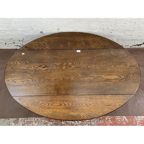 89 - An oak drop leaf oval coffee table