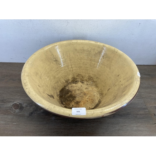 501 - A 19th century terracotta and cream glazed dairy bowl - approx. 20cm high x 45cm diameter