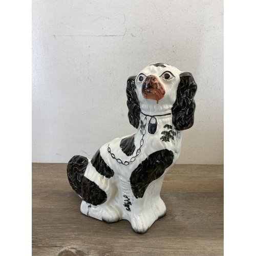 502 - Two Staffordshire King Charles Spaniel figurines, one 19th century and one later - largest approx. 3... 