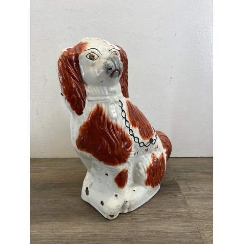 502 - Two Staffordshire King Charles Spaniel figurines, one 19th century and one later - largest approx. 3... 