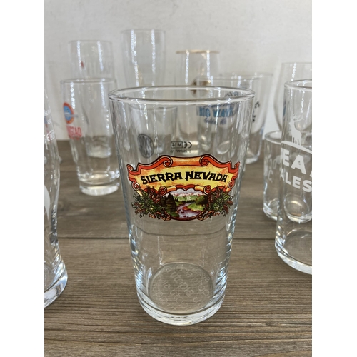 511 - A collection of branded beer glasses to include Hobgoblin, San Miguel, Hogshead etc.