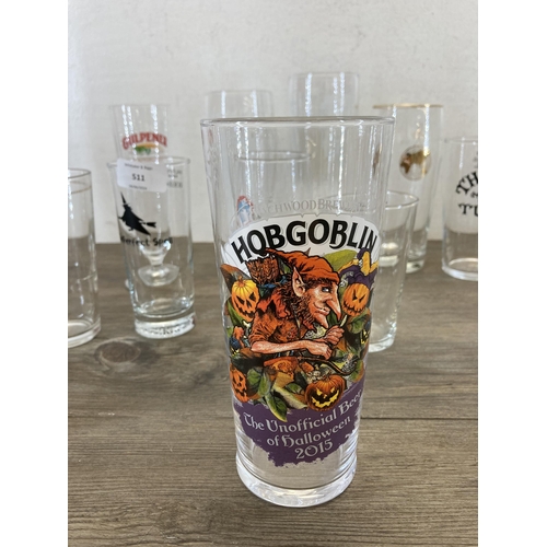 511 - A collection of branded beer glasses to include Hobgoblin, San Miguel, Hogshead etc.