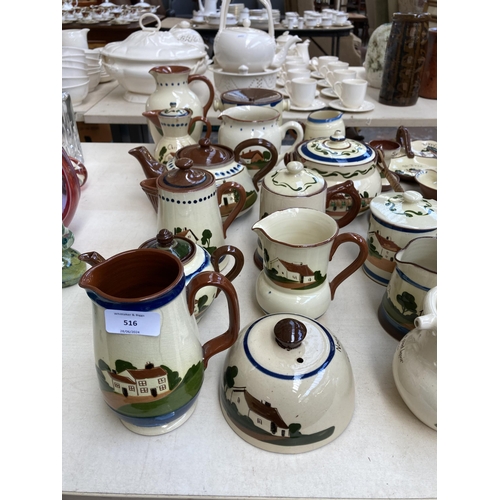 516 - A large collection of Torquay pottery/mottoware to include teapots, water jugs, teacups, serving dis... 