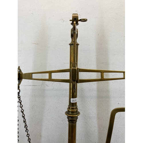 519 - A set of 19th century brass balance scales on stained mahogany base - approx. 59cm high x 53cm wide ... 