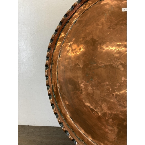 529 - A large early 20th century copper tray/charger - approx. 65cm diameter