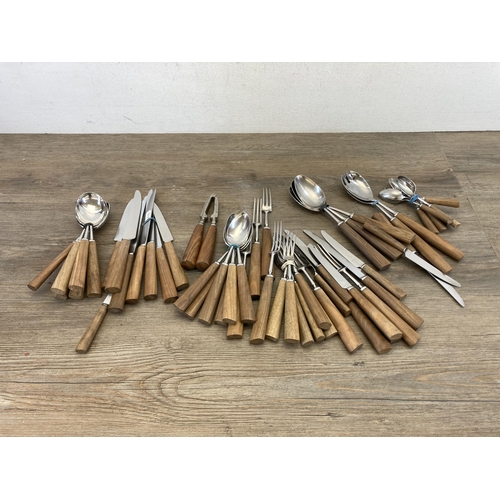 541 - A collection of mid 20th century Mills Moore teak handled cutlery