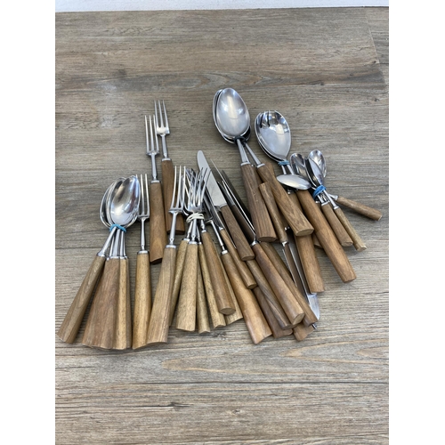 541 - A collection of mid 20th century Mills Moore teak handled cutlery