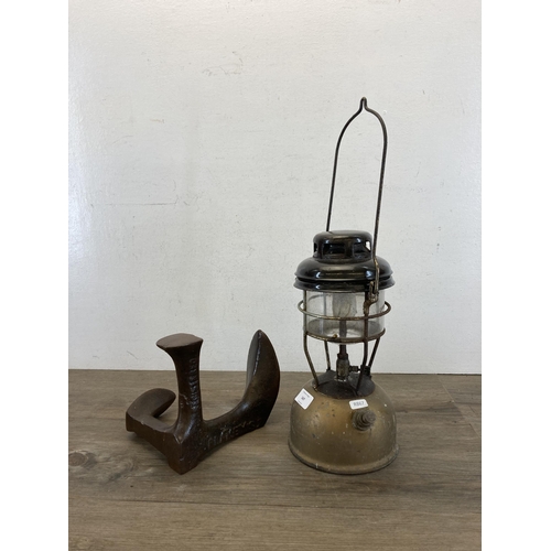 547 - Two items, one vintage gold painted and black enamel paraffin lantern and one cast iron shoe last